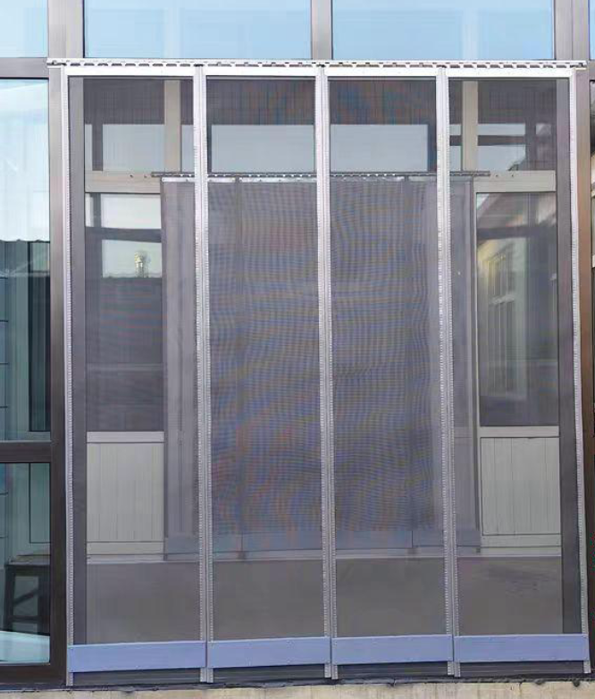 Multi-panel heavy duty magnetic screen door installed at a wide doorway